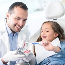 dentist talking to hist patient during her appointment for teeth cleaning for kids in Hurst, TX.