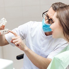 Dentist talking to a patient about the cost of dental implants in Hurst, TX.