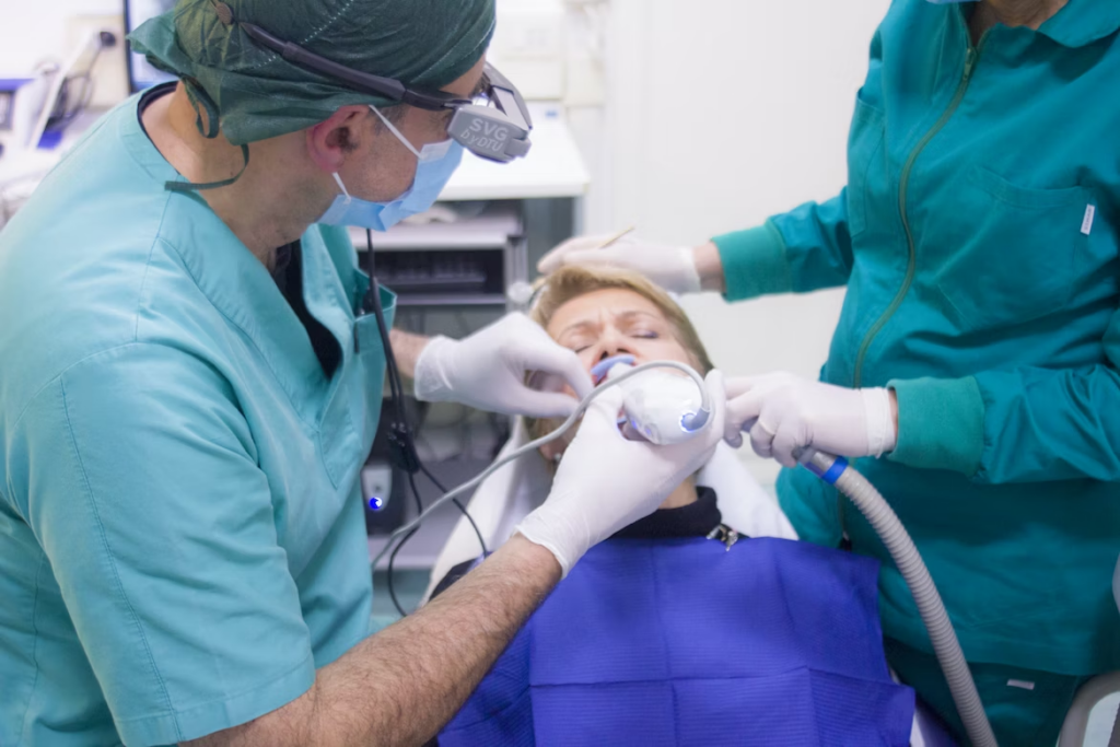 a dentist and dental assistant performing a dental cleaning 