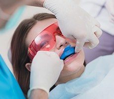 dentist talking to hist patient during her appointment for fluoride treatment for kids in North Richland, TX.
